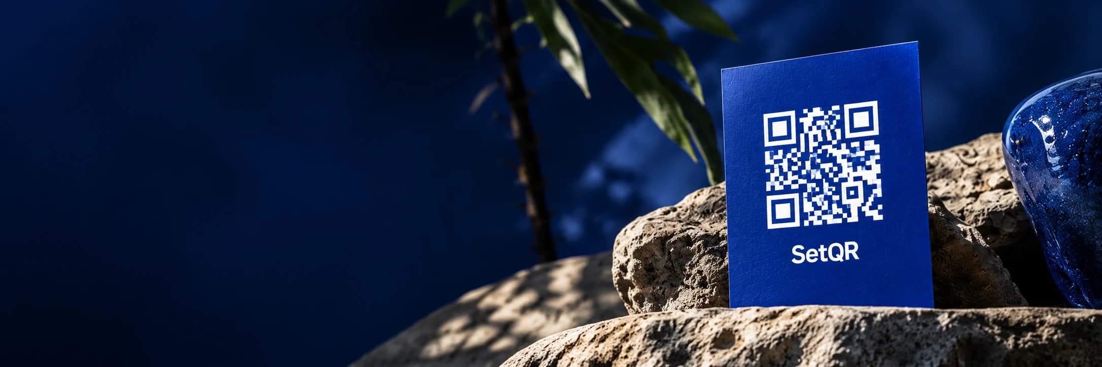 A blue SetQR card standing on natural stone.